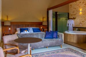 a living room with a couch and a bath tub at Divina Pousada in Pirenópolis +64 photos