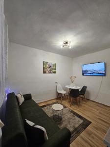 a living room with a couch and a table at Apartman Begovic in Kolašin