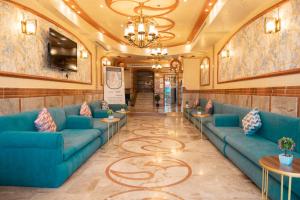 a lobby with blue couches and tables at فندق برادايس نيس النزهة Paradise Nice Hotel in Mecca