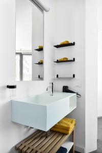 a bathroom with a white sink and a mirror at Private Front Beach Villa with garden and garage in Antibes