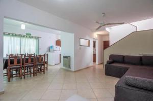 a living room with a couch and a dining room at Soles del lago in Villa Carlos Paz