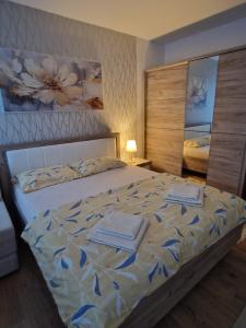 a bedroom with a bed with two towels on it at Esperanto in Vranje