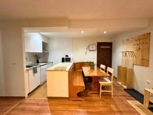 a kitchen with a wooden table and a table and chairs at Apartamento Anayet: Formigal Centro in Formigal