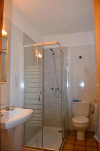 a bathroom with a shower and a toilet and a sink at Residence Can Confort Formentera in Sant Francesc Xavier +10 photos