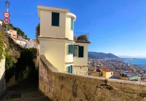 a building on a hill with a view of a city at Le Scale della Minerva in Salerno
