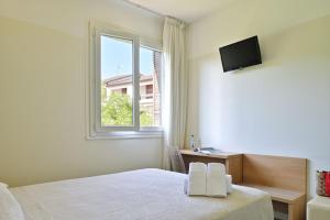 Postel nebo postele na pokoji v ubytování Hôtel de Porticcio