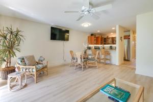 a living room with a table and chairs and a kitchen at Kihei Condo with Resort Amenities Walk to the Beach in Wailea