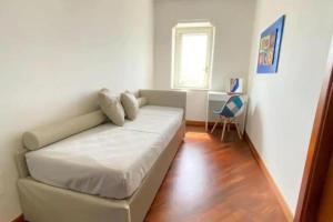 a white couch in a living room with a window at Le Scale della Minerva in Salerno +13 photos
