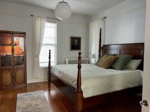 a bedroom with a bed with a wooden headboard at Historic Oak Park Home in Samuel A Rothermel Houses