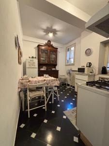 a kitchen with a table and a refrigerator at La Casa Dell'Amore Perfetto in Genova +7 photos
