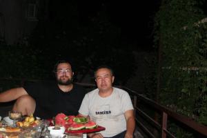 two men sitting at a table with a plate of food at Yurta in Nukus +28 photos