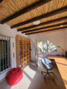 a room with a chair and a desk and a window at Casa Nieves in Roquetas de Mar