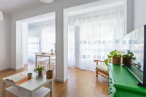 a living room with a green desk and a table at UNIQUE Plaza Higuitos in Almuñécar