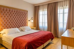 Postel nebo postele na pokoji v ubytování Hotel Boutique ADOLFO