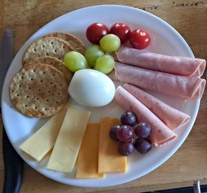 a plate of food with meats and cheese and grapes at Melrose Bed and Breakfast in Clonakilty