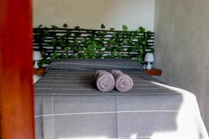 a bedroom with a bed with two purple pillows at La Aldea Zipolite in Zipolite +150 photos