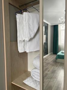 a group of towels are stacked in a closet at Sairam-16 уютная квартира Nurly zhol in Promyshlennyy
