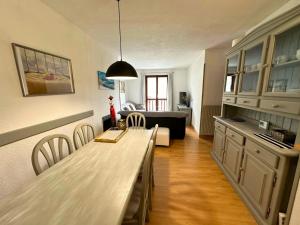 a kitchen with a long table and a living room at Cervino 2 Apartamento en Formigal Pueblo in Formigal