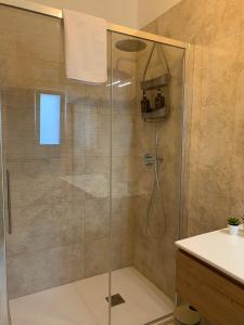 a bathroom with a shower with a glass door at B&B Casa Prencipe in Mattinata +35 photos