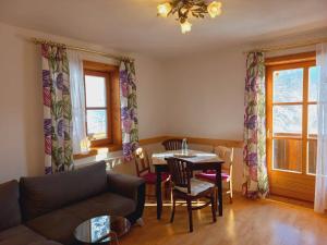 a living room with a couch and a table at Landhof Kreuzsalgut in Wagrain