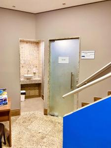 a bathroom with a door leading to a sink at Hotel Porto Salvador in Salvador
