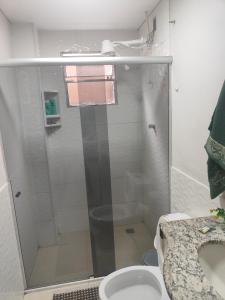 a bathroom with a shower with a toilet and a sink at Studio mobiliado 3 in Contagem
