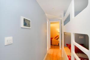 a white room with a staircase and a bedroom at Le 24 in Les Deux Alpes