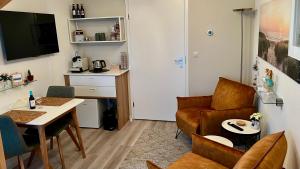 a living room with a couch and a table at Thuis op Texel in Den Burg