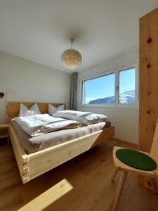 a bedroom with a bed and a large window at Ferienwohnung CAMANABODA in Camanaboda