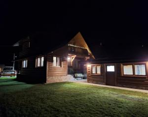 a house at night with lights on the side at Drevenica Skye Terchová in Terchová
