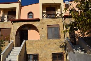 a building with an arch and stairs in front of it at Azure Dream, Pool Edge, Nikiti in Nikiti