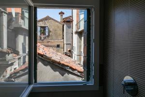 a view from a window of a city street at San Marco Comfort in Venice