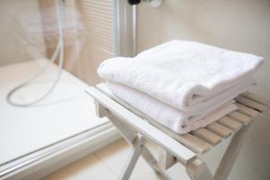 a pile of towels sitting on a rack in a bathroom at San Marco Comfort in Venice +15 photos