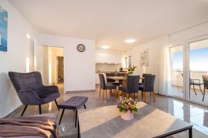 a living room with a table and chairs at Apartment ILUX-3 in Novigrad Dalmatia