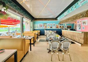 a dining room with tables and chairs in a restaurant at Beachfront Ocean View Apartment on Ocean Drive in Miami Beach