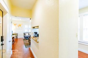 a living room and dining room with a white wall at Can't Buy Me Love - U of Tampa Flat in N Hyde Park in Tampa +40 photos