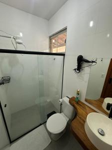 a bathroom with a toilet and a shower and a sink at Casa Jubarte in Alcobaça +23 photos