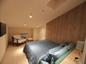 una camera con letto, sedia e televisore di Two-storey apartment BlockF1 a Kʼumlistsʼikhe