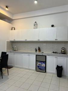 a kitchen with white cabinets and a counter top at Dajon #7 Superior STE-Generator & Starlink in General Luna