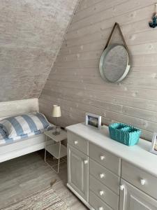a bedroom with a bed and a mirror on the wall at pod lipą in Ustka +32 photos