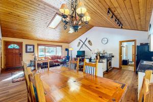 a dining room and living room with a wooden ceiling at Ollie's Place in Breckenridge