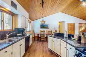 a kitchen with a sink and a dining room at Ollie's Place in Breckenridge +13 photos