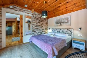 a bedroom with a bed and a brick wall at Zagorska Bajka in Krapina +31 photos