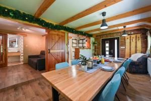 a dining room with a wooden table and blue chairs at Zagorska Bajka in Krapina