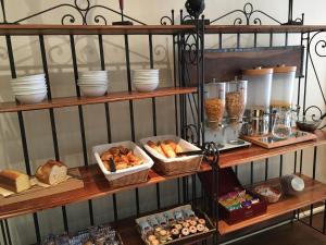 a shelf filled with different types of bread and pastries at Hotel Antin St Georges in Paris