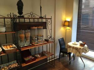 a room with a table and a table and a dining room at Hotel Antin St Georges in Paris