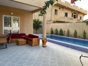 a swimming pool sitting next to a building at Maison de vacances in Mbour