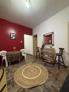 a living room with a table and chairs and a mirror at Barra Mar in Salvador