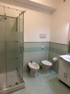 a bathroom with a shower and a toilet and a sink at casavacanzabordonaro in Palermo +19 photos
