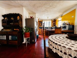 a kitchen with a table and a refrigerator in a room at Casa Piña in Villa de Leyva